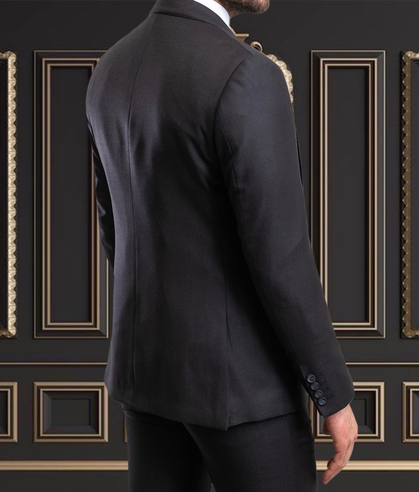 Rear view of a man in a premium black wool suit against a sophisticated backdrop, showcasing tailored elegance.