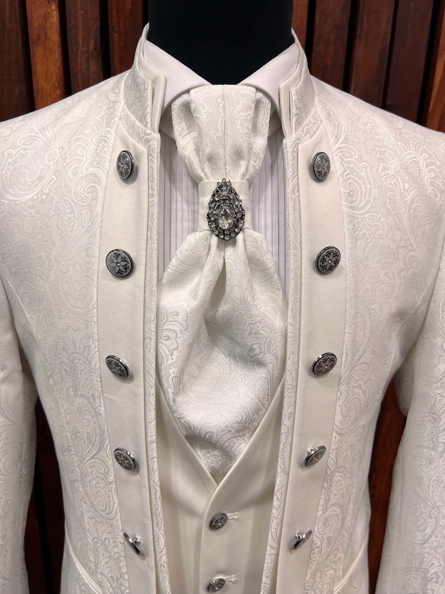 Men's white floral tuxedo with mandarin collar, featuring elegant detailing and intricate buttons.