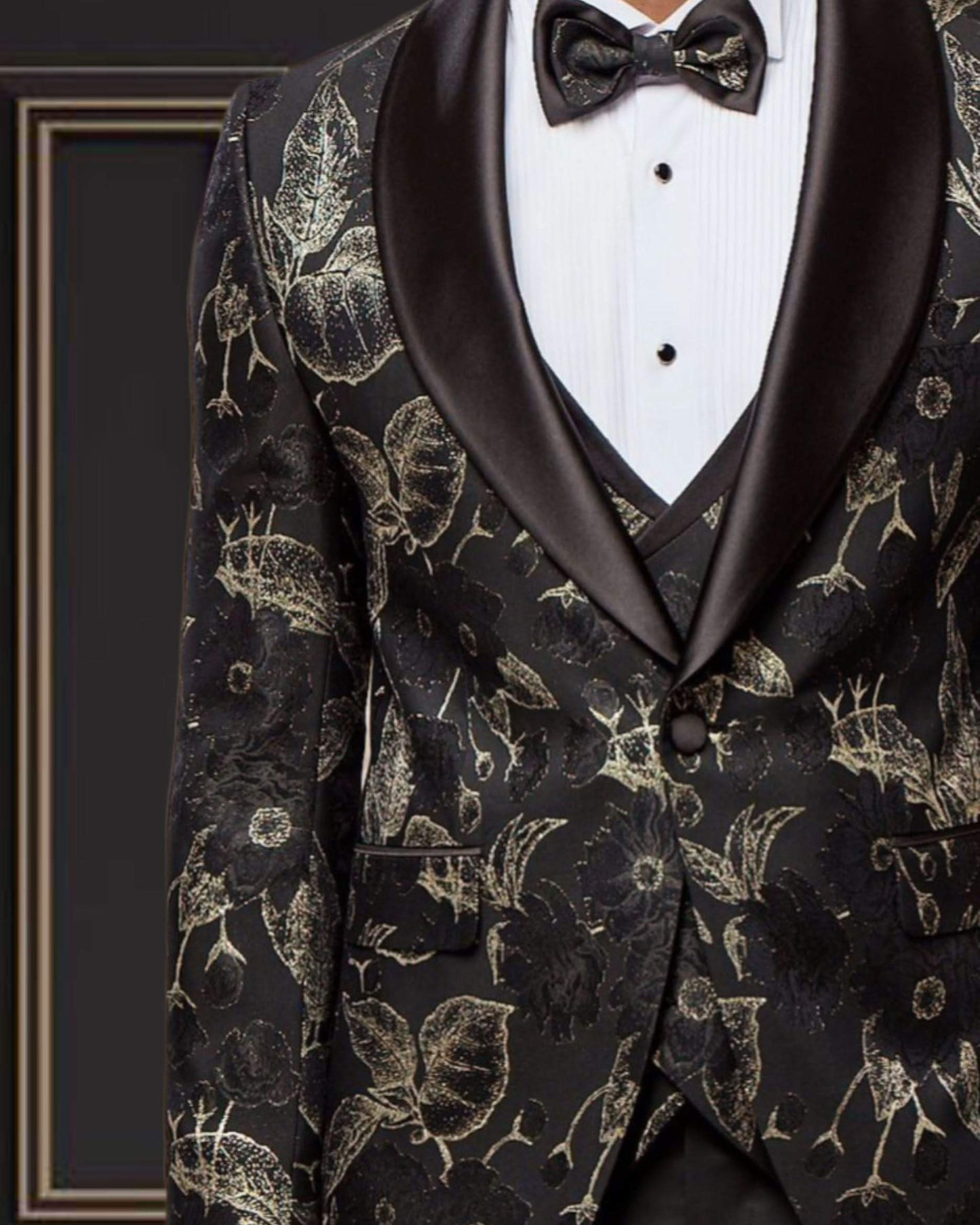 Elegant black and gold floral shawl lapel tuxedo with bow tie, ideal for formal events.